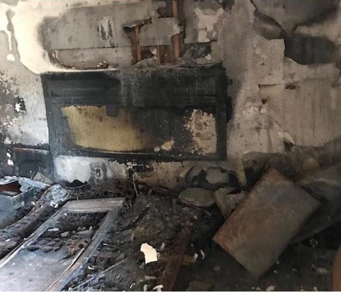Fire damaged room covered in soot and debris