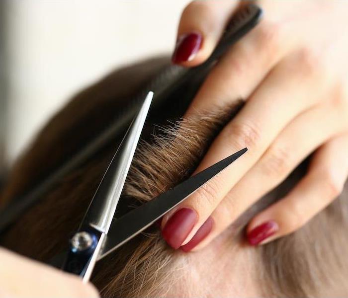 Female hand hold hair scissors, cutting hair