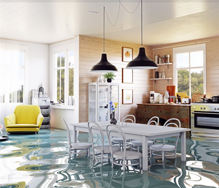 a flooded kitchen with furniture floating and water covering the floors