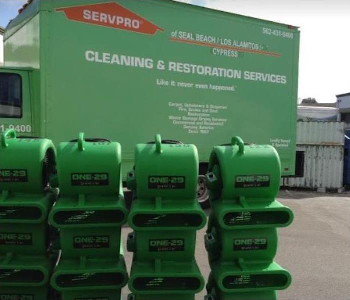 SERVPRO drying equipment stacked outside of SERVPRO vehicle